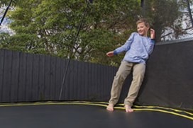 Black trampoline with a black safety net.