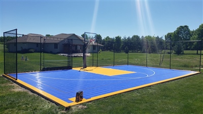 A basketball court with a blue surface and yellow surface with white lines.