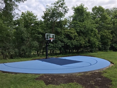 A basketball court with a curved design, featuring a light and dark blue surface with dark blue lines.