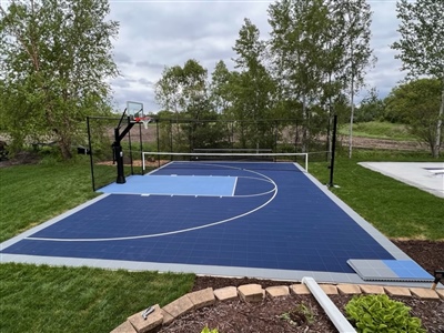  A basketball court with a navy and blue surface, grey border, and white lines in Hopkins.